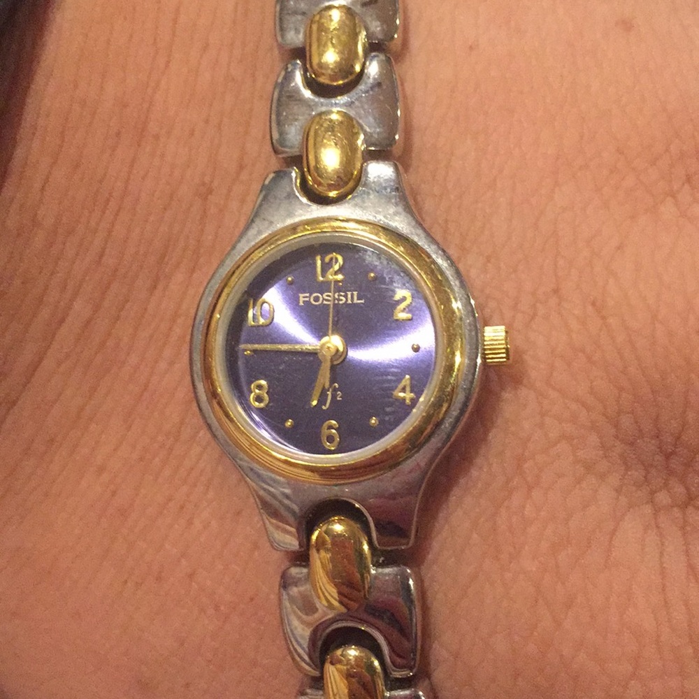Fossil gold and silver-tone link watch.